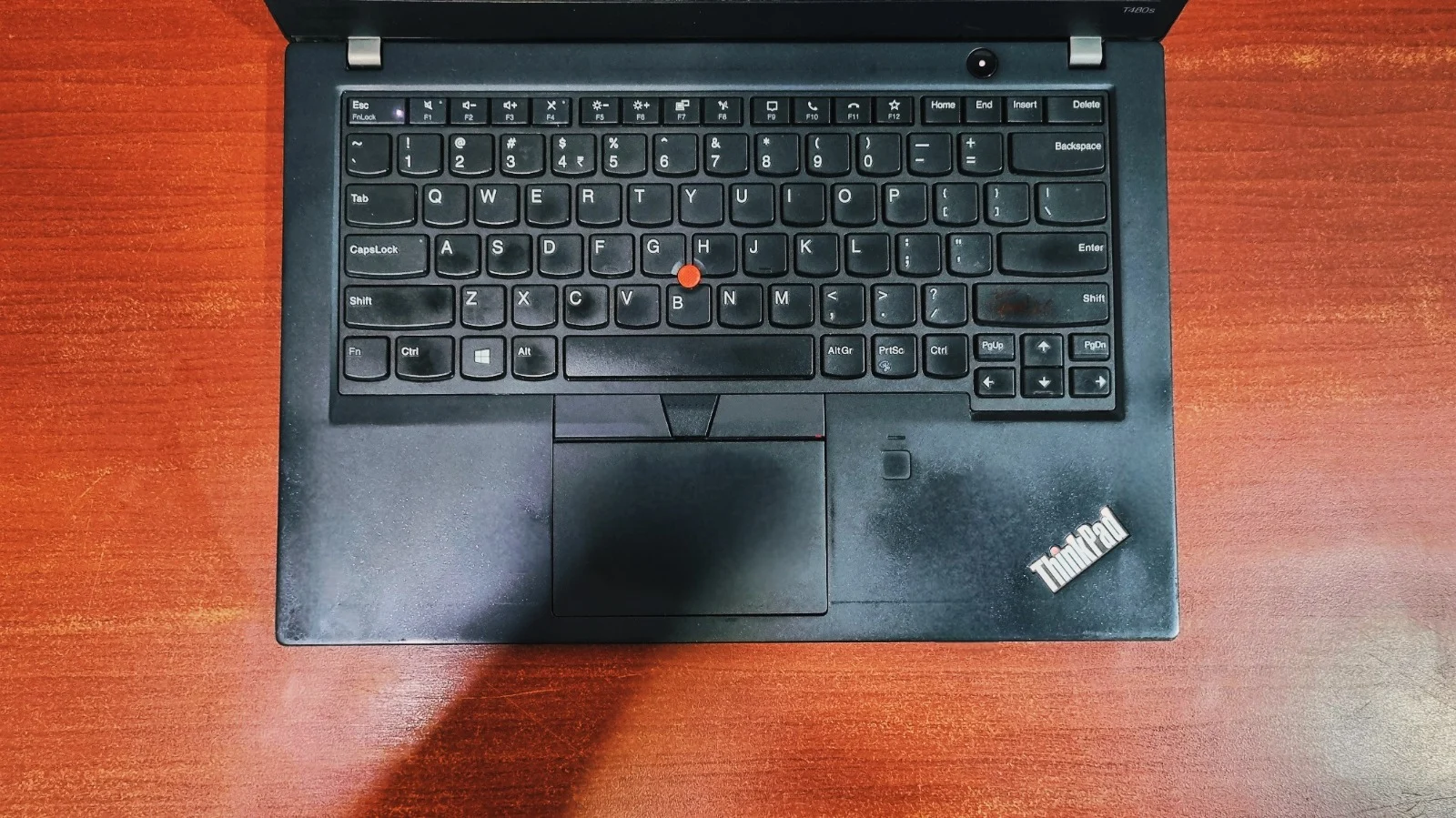 Lenovo ThinkPad T480s backlit keyboard with red TrackPoint nub and glass touchpad
